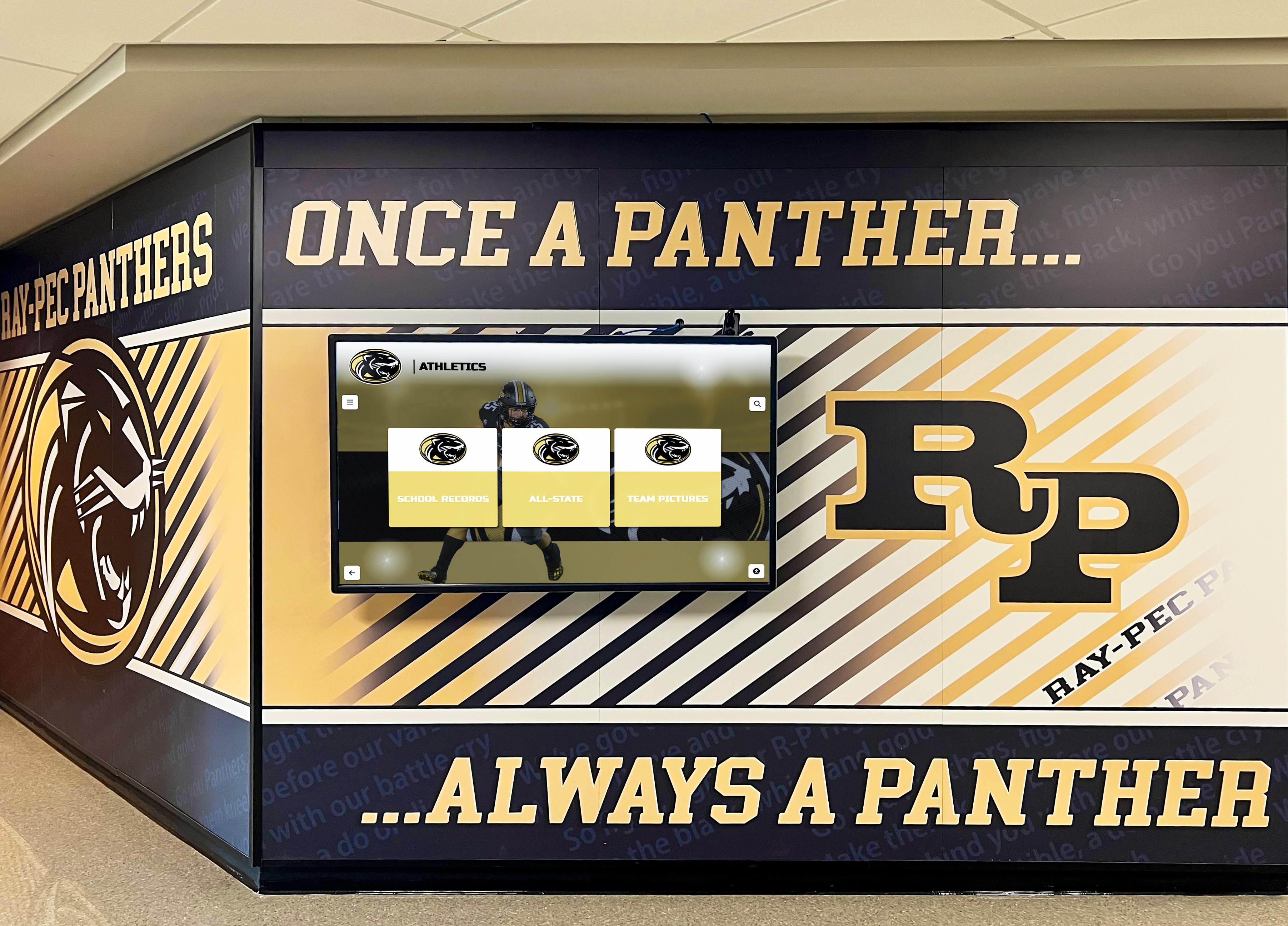 School hallway with panther athletics mural and digital recognition screen